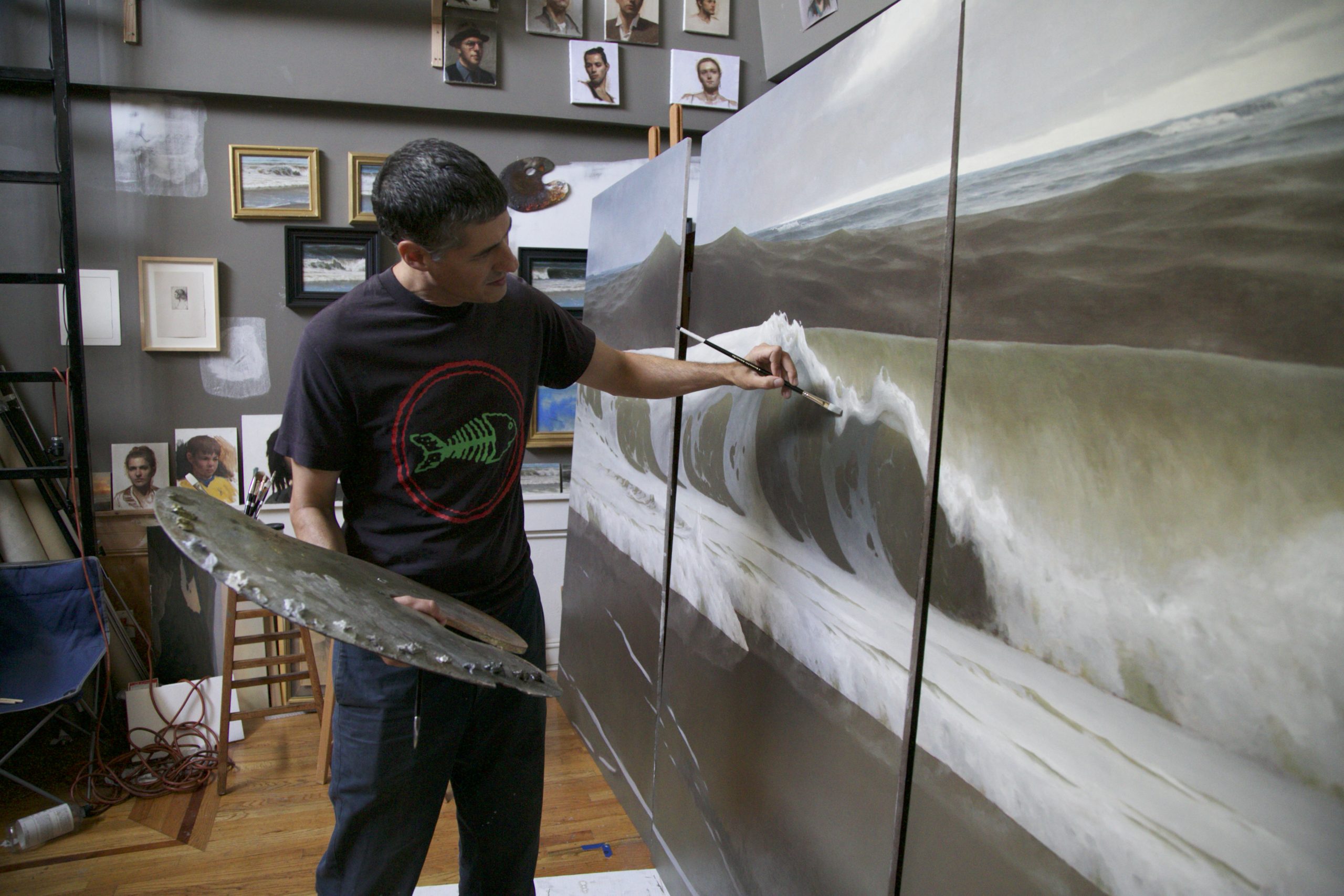 Artist, Edward Minoff works on his seascape painting, tittled 